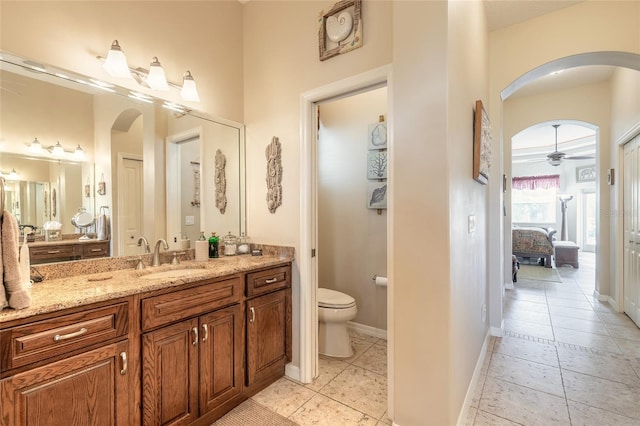 bathroom featuring tile patterned floors, vanity, toilet, and ceiling fan