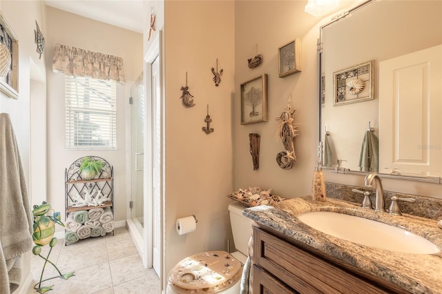 bathroom featuring tile patterned flooring, vanity, and walk in shower