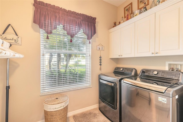 laundry area with plenty of natural light, cabinets, and washing machine and dryer