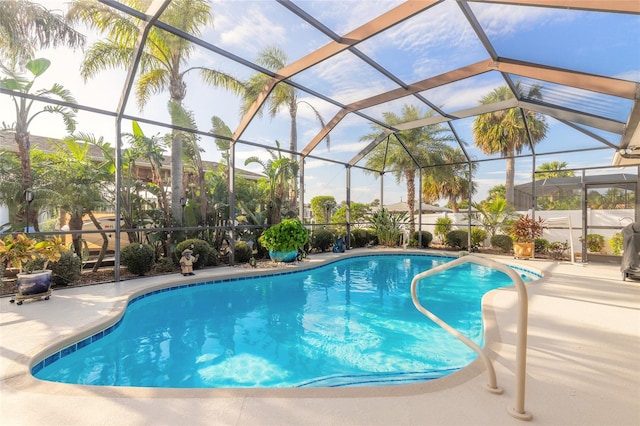 view of swimming pool featuring a patio area and glass enclosure