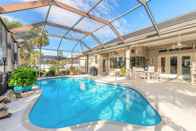 view of pool with a lanai, ceiling fan, french doors, and a patio