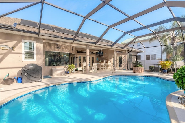 view of pool with a patio, area for grilling, ceiling fan, and a lanai