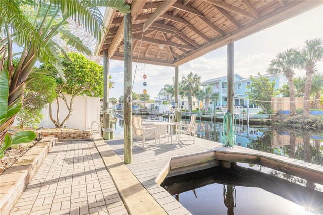 exterior space featuring a water view and a boat dock