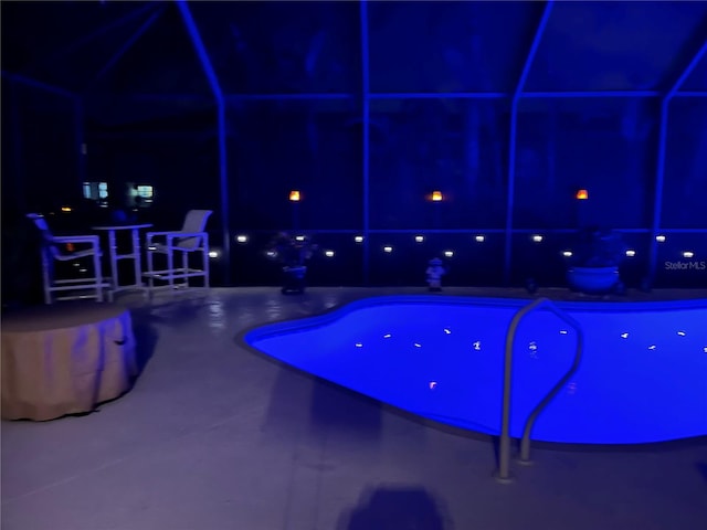 view of pool at twilight