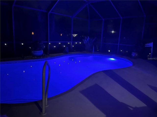 view of pool at night