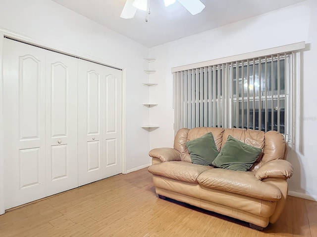 sitting room featuring wood-type flooring and ceiling fan