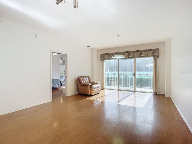 spare room featuring wood-type flooring and ceiling fan