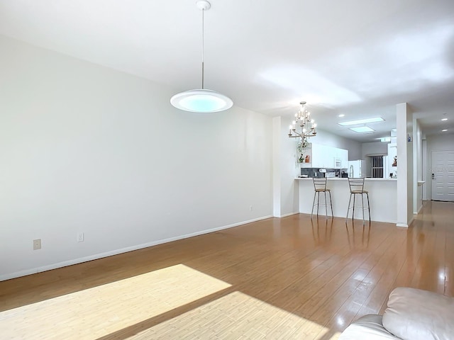 living room featuring light hardwood / wood-style flooring and a notable chandelier