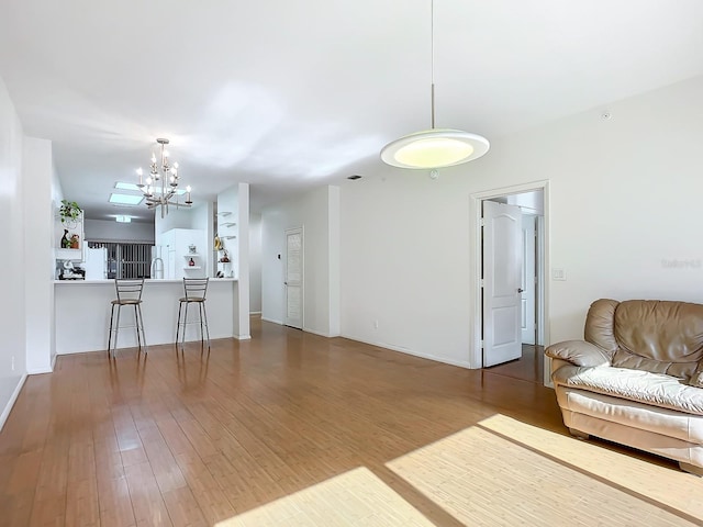 living room featuring hardwood / wood-style floors and a notable chandelier