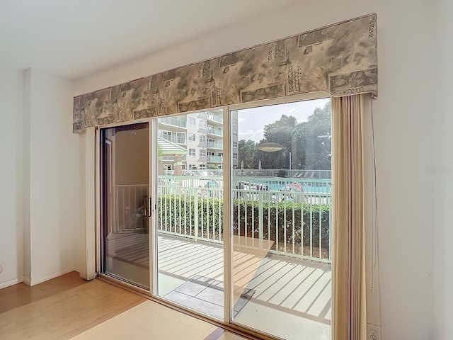 doorway with hardwood / wood-style flooring