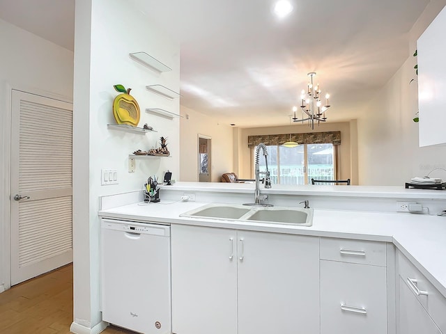 kitchen with an inviting chandelier, sink, white cabinets, dishwasher, and light hardwood / wood-style flooring