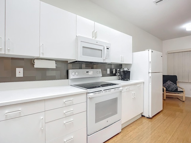 kitchen with light wood-type flooring, white appliances, backsplash, and white cabinets