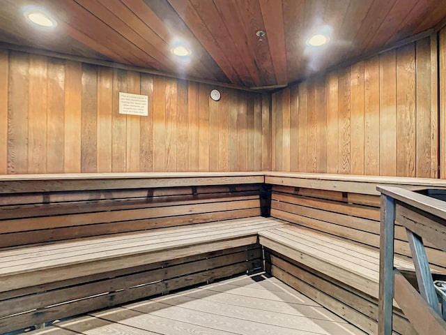 view of sauna / steam room featuring hardwood / wood-style floors, wooden walls, and wood ceiling