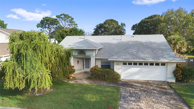 ranch-style home with a front lawn and a garage