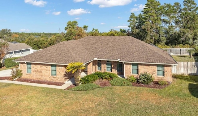 ranch-style house featuring a front lawn and brick siding