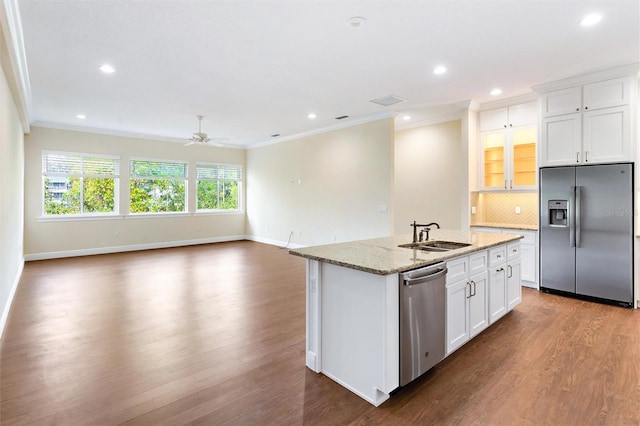 kitchen featuring white cabinetry, appliances with stainless steel finishes, a center island with sink, and dark hardwood / wood-style flooring