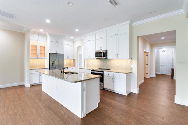 kitchen with wood-type flooring, white cabinetry, and appliances with stainless steel finishes