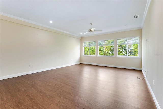 spare room featuring ornamental molding, dark hardwood / wood-style flooring, and ceiling fan