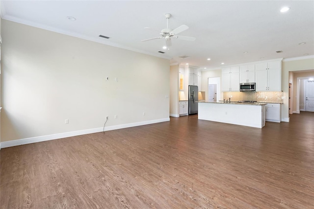 unfurnished living room with ceiling fan, dark hardwood / wood-style floors, sink, and crown molding