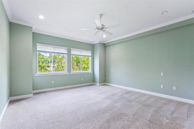 carpeted empty room with ornamental molding and ceiling fan