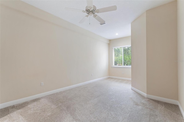 empty room with light carpet and ceiling fan