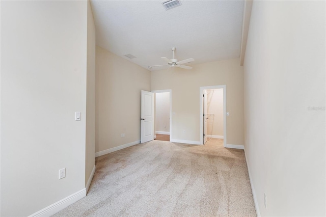 unfurnished room featuring light colored carpet and ceiling fan