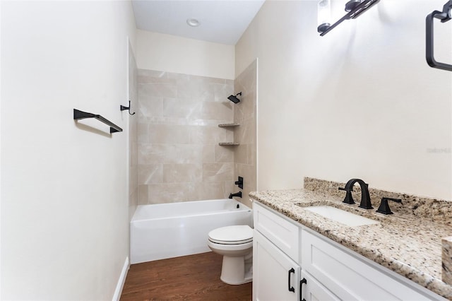 full bathroom with hardwood / wood-style flooring, vanity, toilet, and tiled shower / bath combo