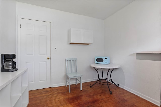 laundry area with dark hardwood / wood-style floors