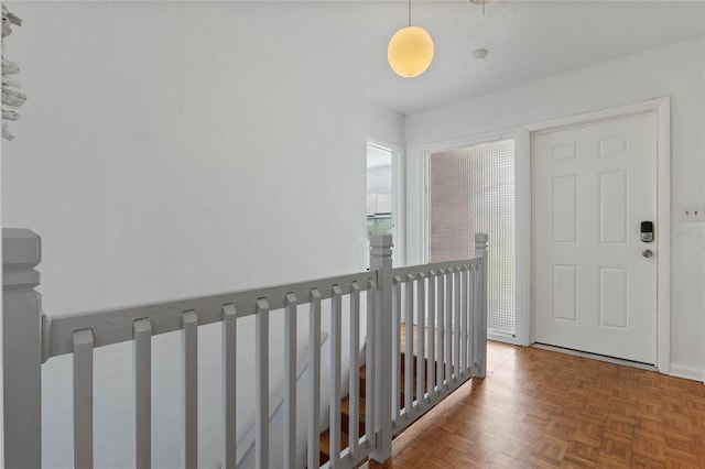 hallway featuring dark parquet flooring