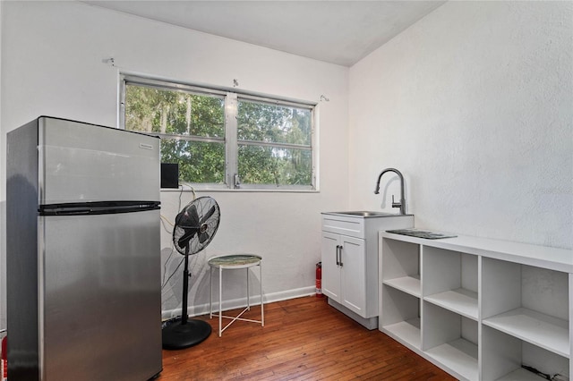 interior space featuring hardwood / wood-style flooring and sink