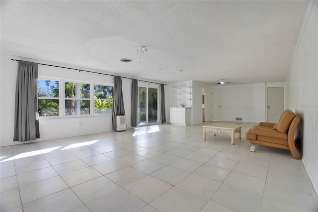 unfurnished living room featuring light tile patterned flooring and a textured ceiling