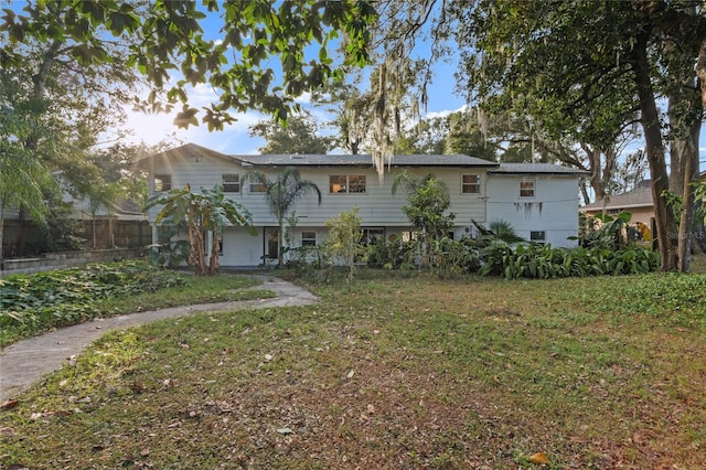 rear view of property with a lawn