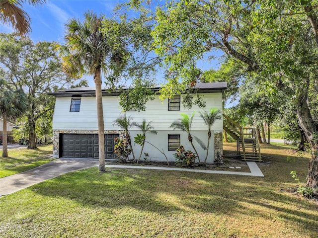 view of front of property with a front yard and a garage