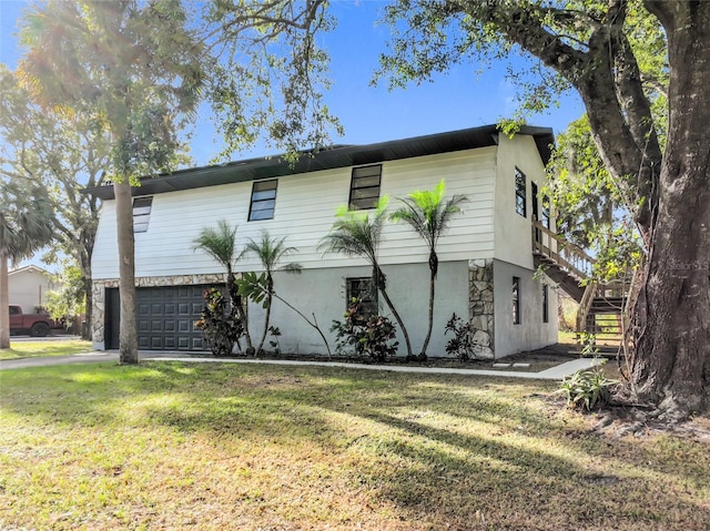 view of front of property with a garage and a front lawn