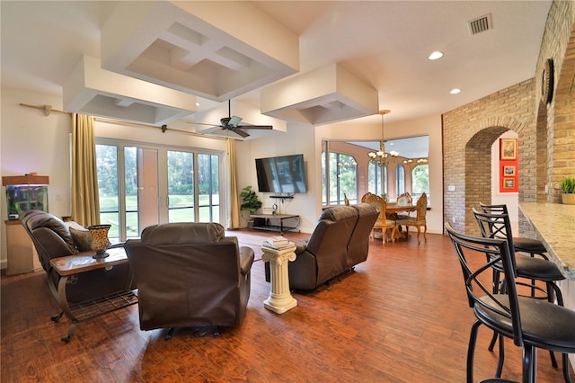 living room featuring hardwood / wood-style floors and ceiling fan with notable chandelier