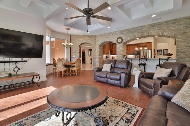 living room featuring ceiling fan with notable chandelier and dark hardwood / wood-style flooring