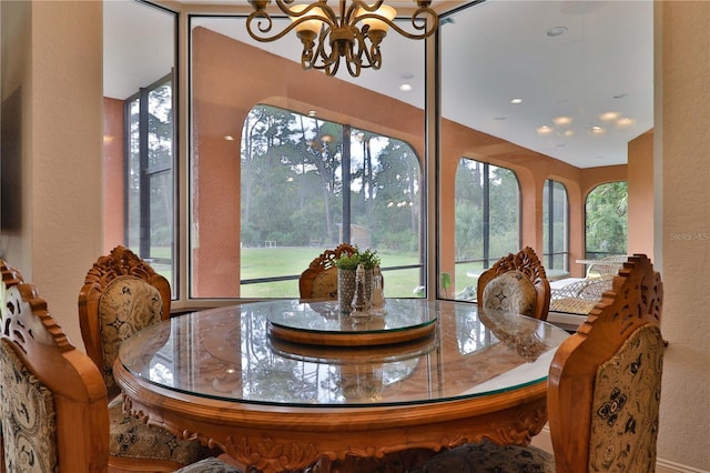 dining room featuring a healthy amount of sunlight and a chandelier