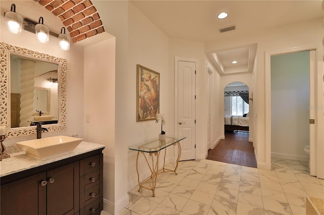 bathroom featuring hardwood / wood-style flooring, vanity, and toilet