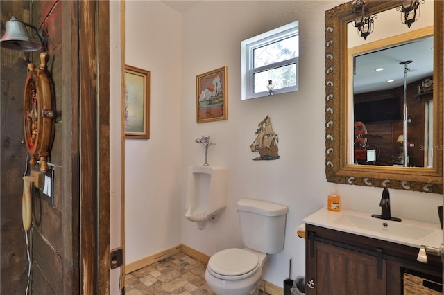 bathroom featuring toilet and vanity