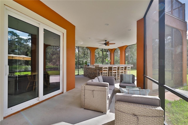 sunroom with a wealth of natural light and ceiling fan