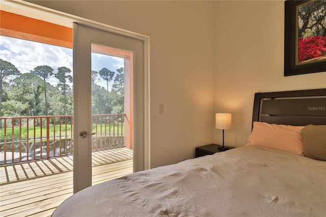 bedroom featuring access to exterior and hardwood / wood-style flooring