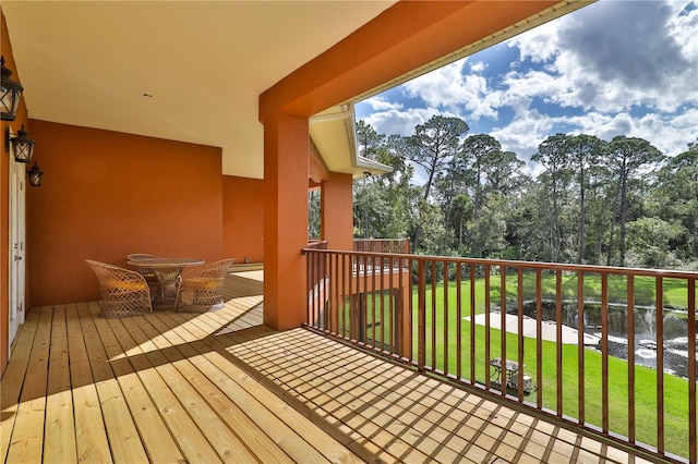 wooden deck with a lawn