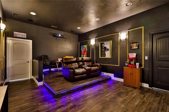 home theater with a textured ceiling and dark hardwood / wood-style floors