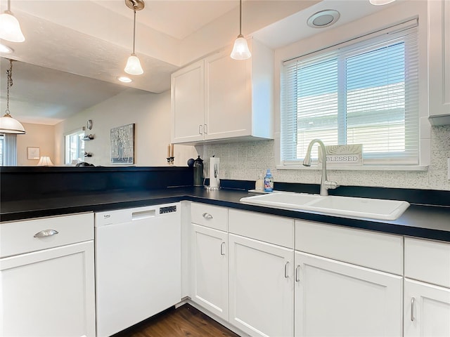 kitchen with sink, pendant lighting, dishwasher, and tasteful backsplash