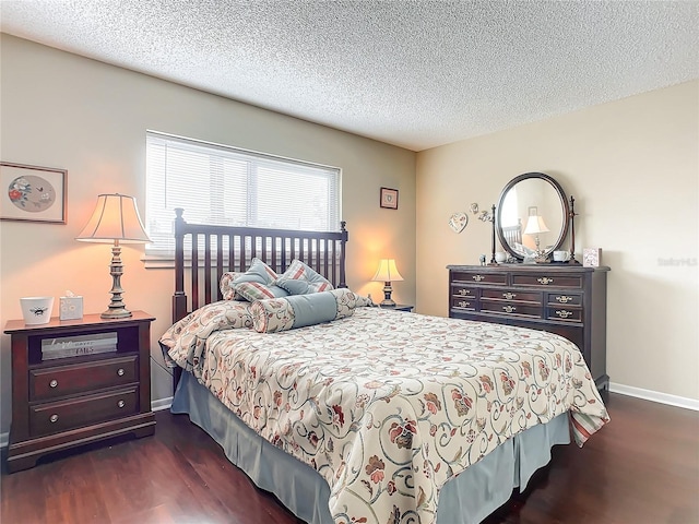 bedroom featuring a textured ceiling and dark hardwood / wood-style flooring