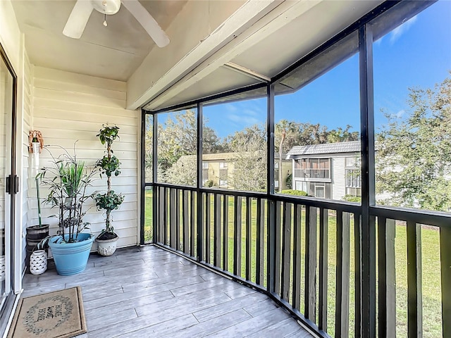 sunroom featuring ceiling fan