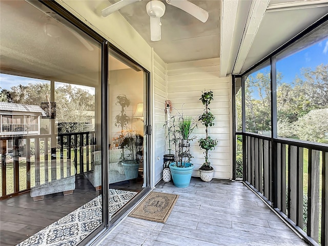 sunroom / solarium featuring a wealth of natural light and ceiling fan