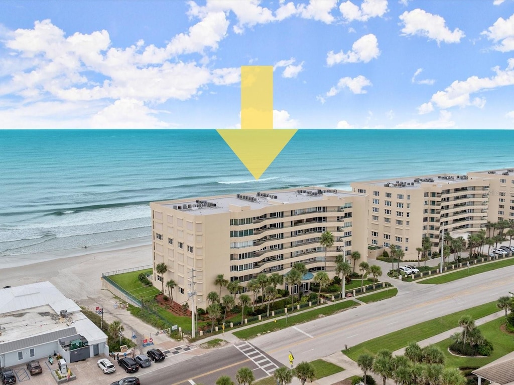 birds eye view of property featuring a view of the beach and a water view