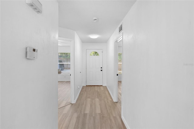 hallway with light hardwood / wood-style flooring