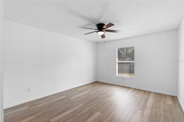 unfurnished room featuring a textured ceiling, light hardwood / wood-style floors, and ceiling fan